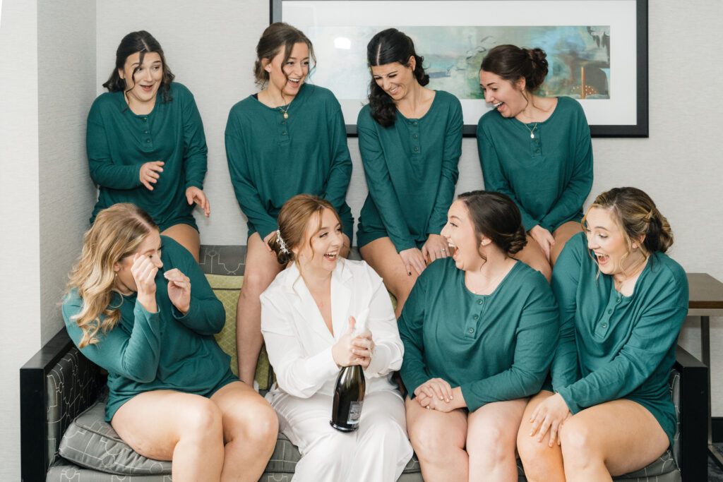 Bridesmaids toasting with champagne in matching robes at Embassy Suites Pittsburgh Downtown