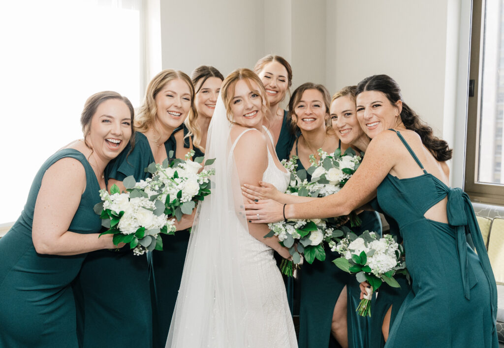 Bride’s bridesmaids reacting with excitement and joy during the first look at Embassy Suites Pittsburgh Downtown.