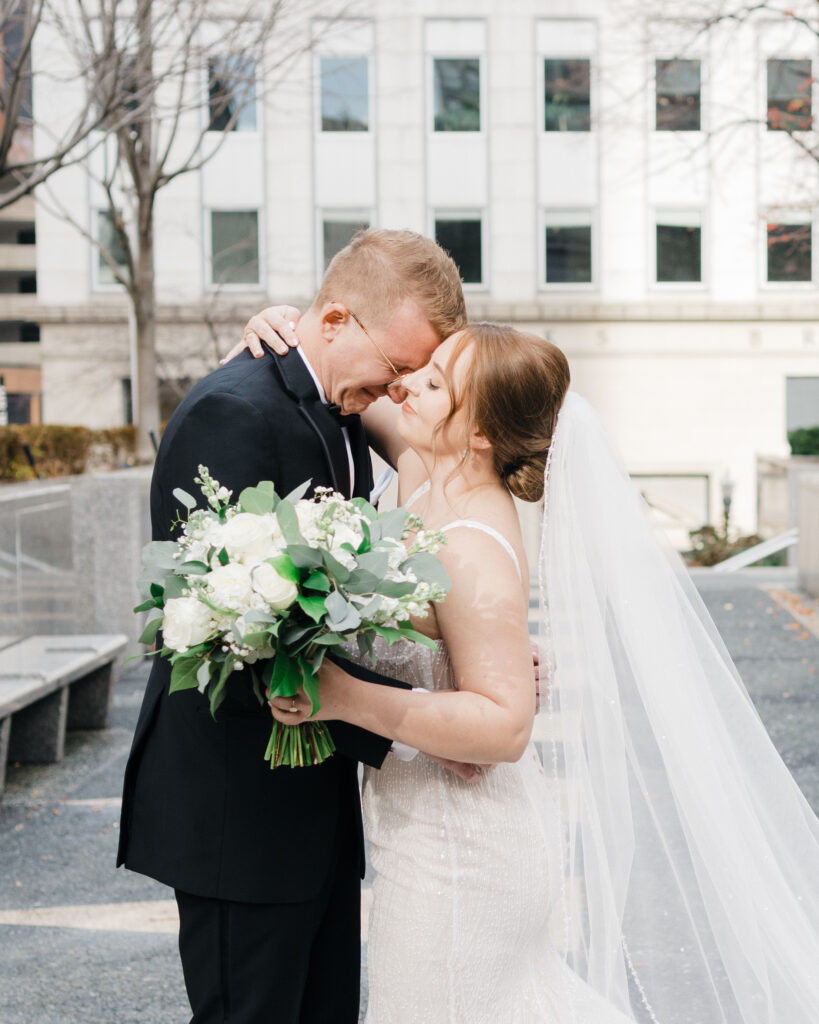 Tearful groom wiping his eyes during a heartfelt first look moment with the bride at Embassy Suites Pittsburgh.