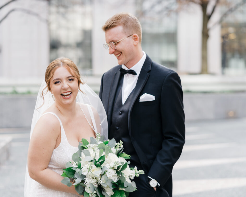 Bride and groom smiling warmly at each other during a romantic moment at Embassy Suites Pittsburgh Downtown.