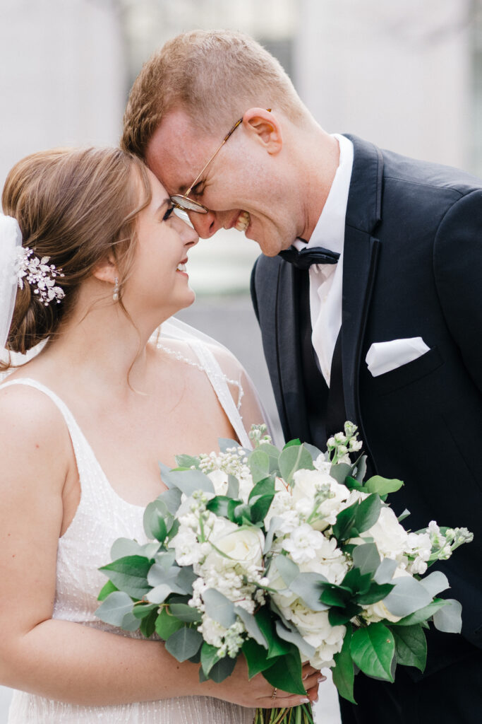 Bride and groom gazing lovingly at each other with smiles at Embassy Suites Pittsburgh.