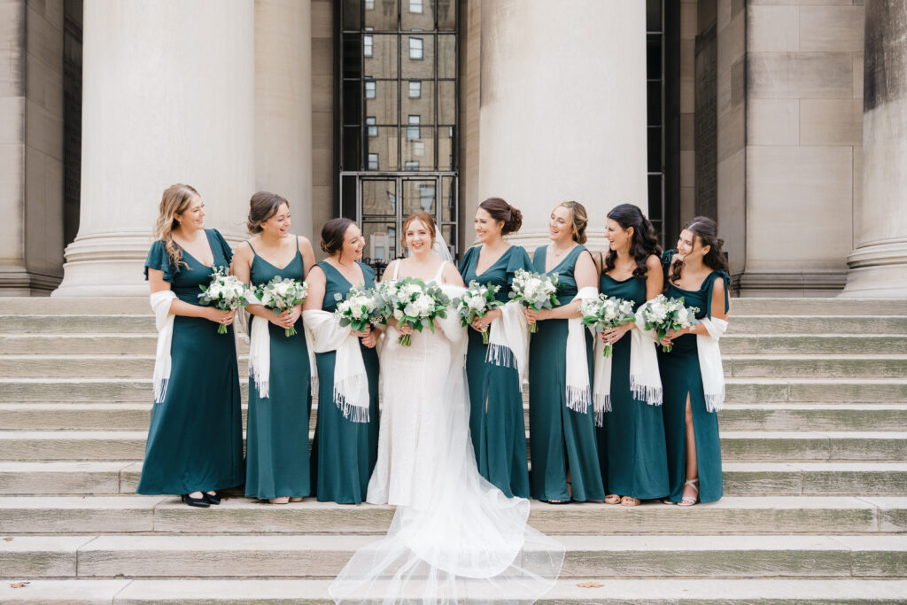 Candid moment of bridesmaids smiling together before the ceremony at Embassy Suites Pittsburgh.