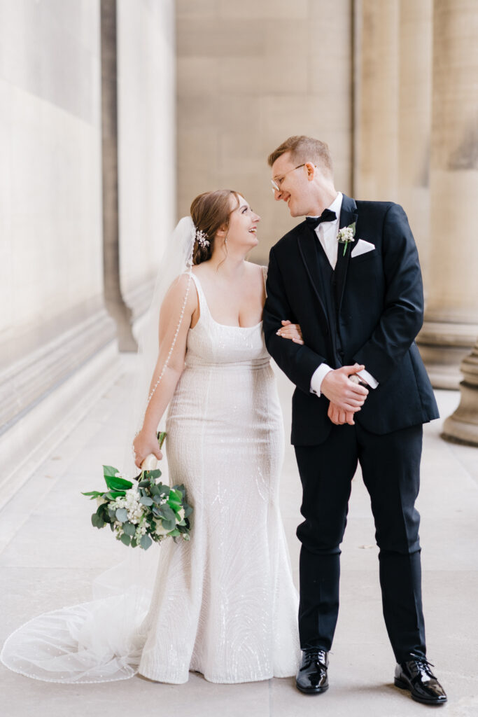 Bride and groom holding hands, sharing a quiet and intimate moment during their wedding day at Embassy Suites Pittsburgh Downtown.