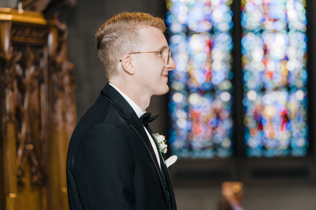 Groom waiting at the altar for the bride during the ceremony at Heinz Chapel.