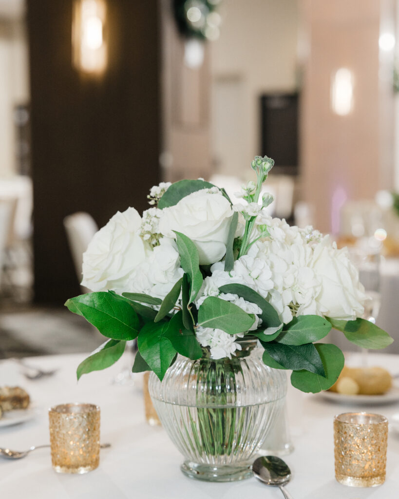 Elegant floral centerpiece with pastel flowers decorating the reception tables at Embassy Suites Pittsburgh Downtown.