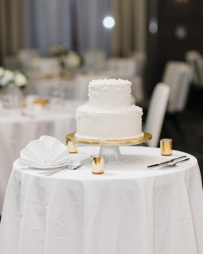 Bride and groom’s elegant wedding cake highlighted on the dessert table at Embassy Suites Pittsburgh Downtown.