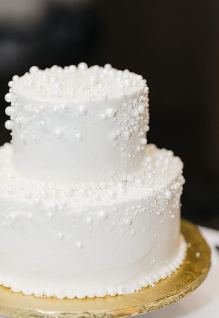 two-tier wedding cake with intricate details displayed at the reception in Embassy Suites Pittsburgh