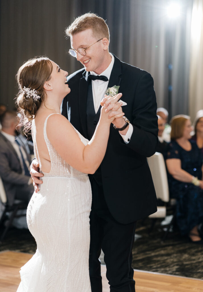 Bride and groom sharing a romantic first dance under the spotlight at Embassy Suites Pittsburgh Downtown.