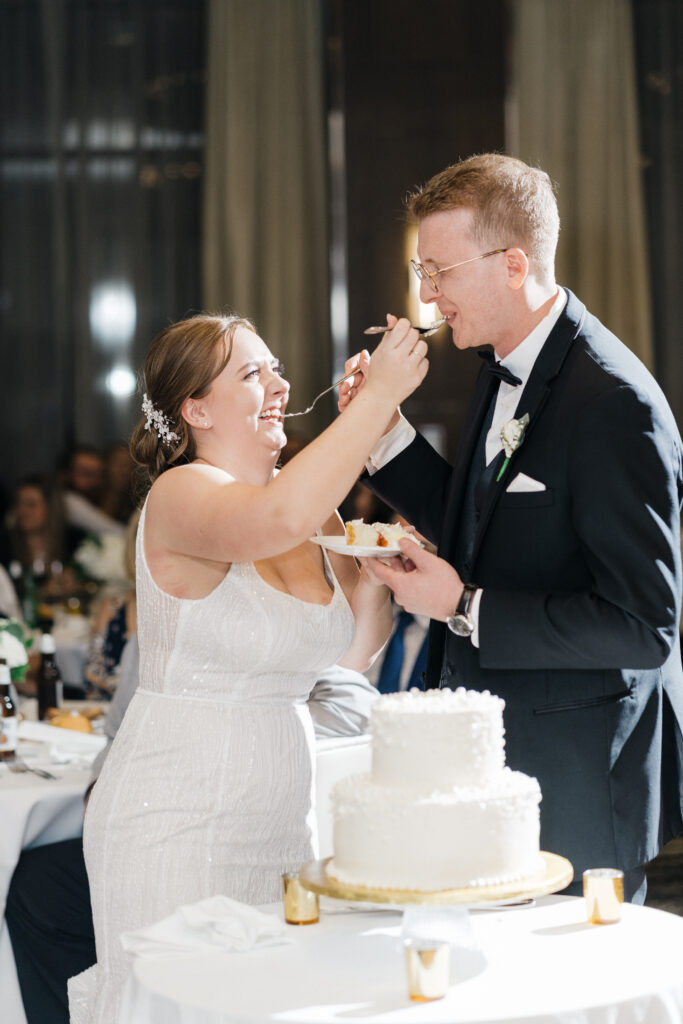 Bride and groom cutting their wedding cake together during the reception at Embassy Suites Pittsburgh Downtown.