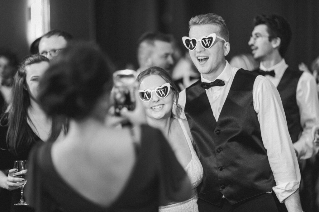 Bride and groom wearing sunglasses in the middle of the dance floor, captured candidly by a guest at Embassy Suites Pittsburgh Downtown.