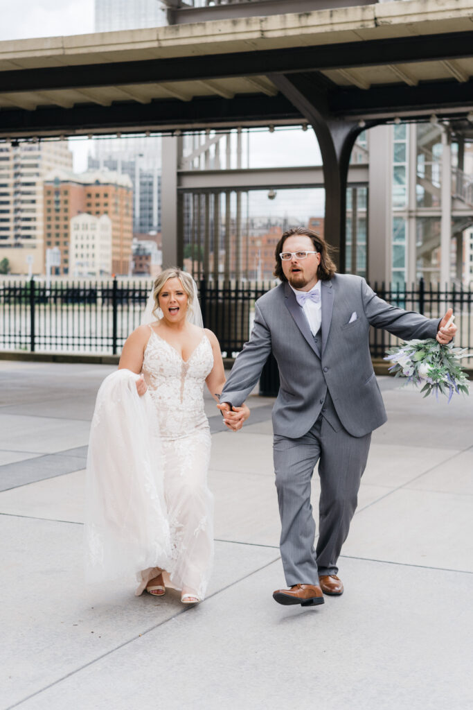 Couple walking along Pittsburgh riverwalk during Sheraton Station Square wedding